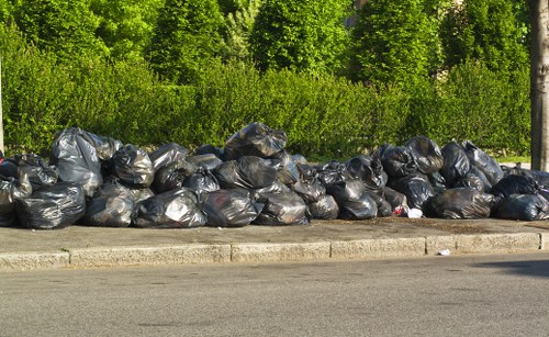 Workers using protective equipment while loading waste